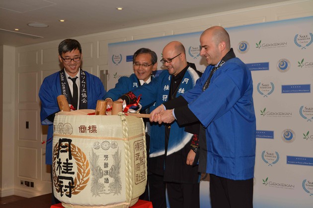 Sake sommelier finalists help break a cask of sake 